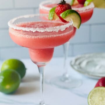 frozen strawberry margaritas garnished with lime
