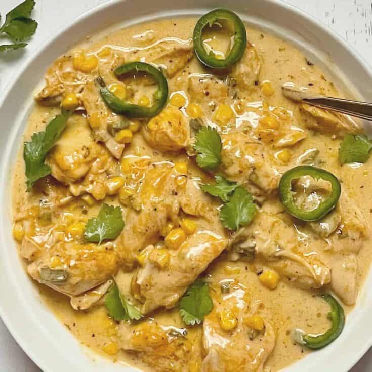 jalapeno cheddar chicken topped with cilantro and jalapenos in a white bowl