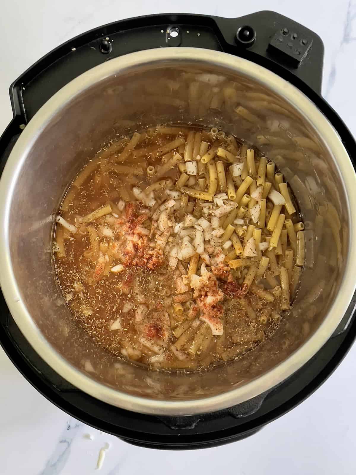 ziti, broth, cajun spices in the pressure cooker