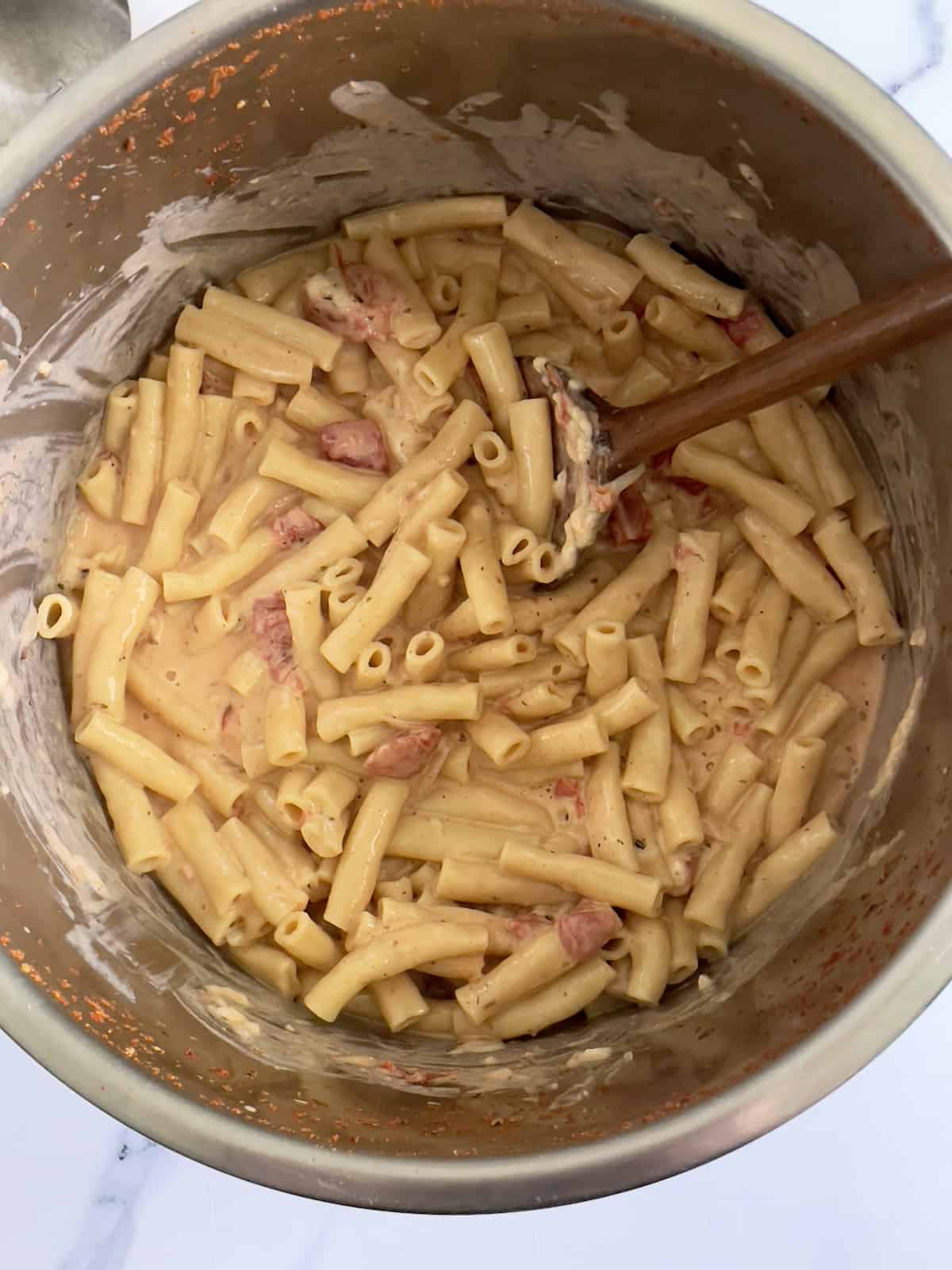 cooked pasta combined with a cheesy sauce in the inner pot
