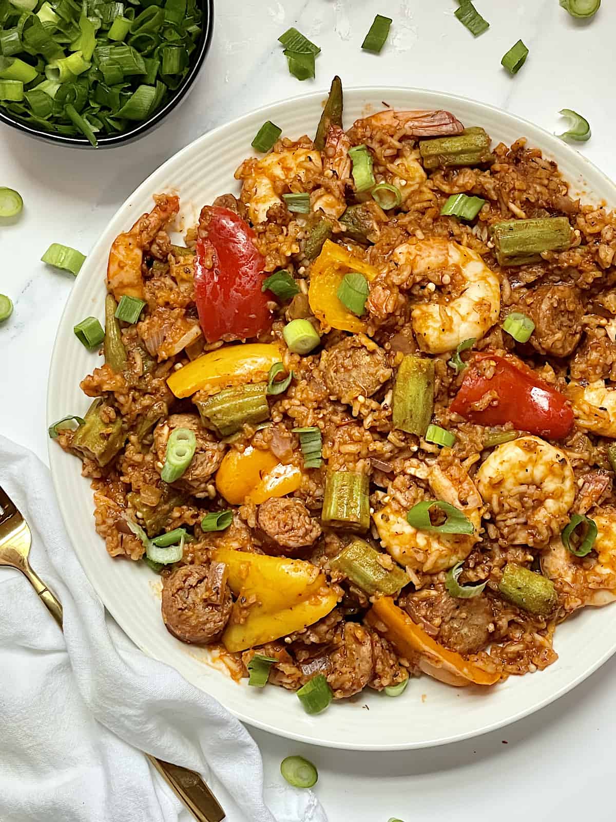 instant pot jambalaya in a white dish topped with scallions
