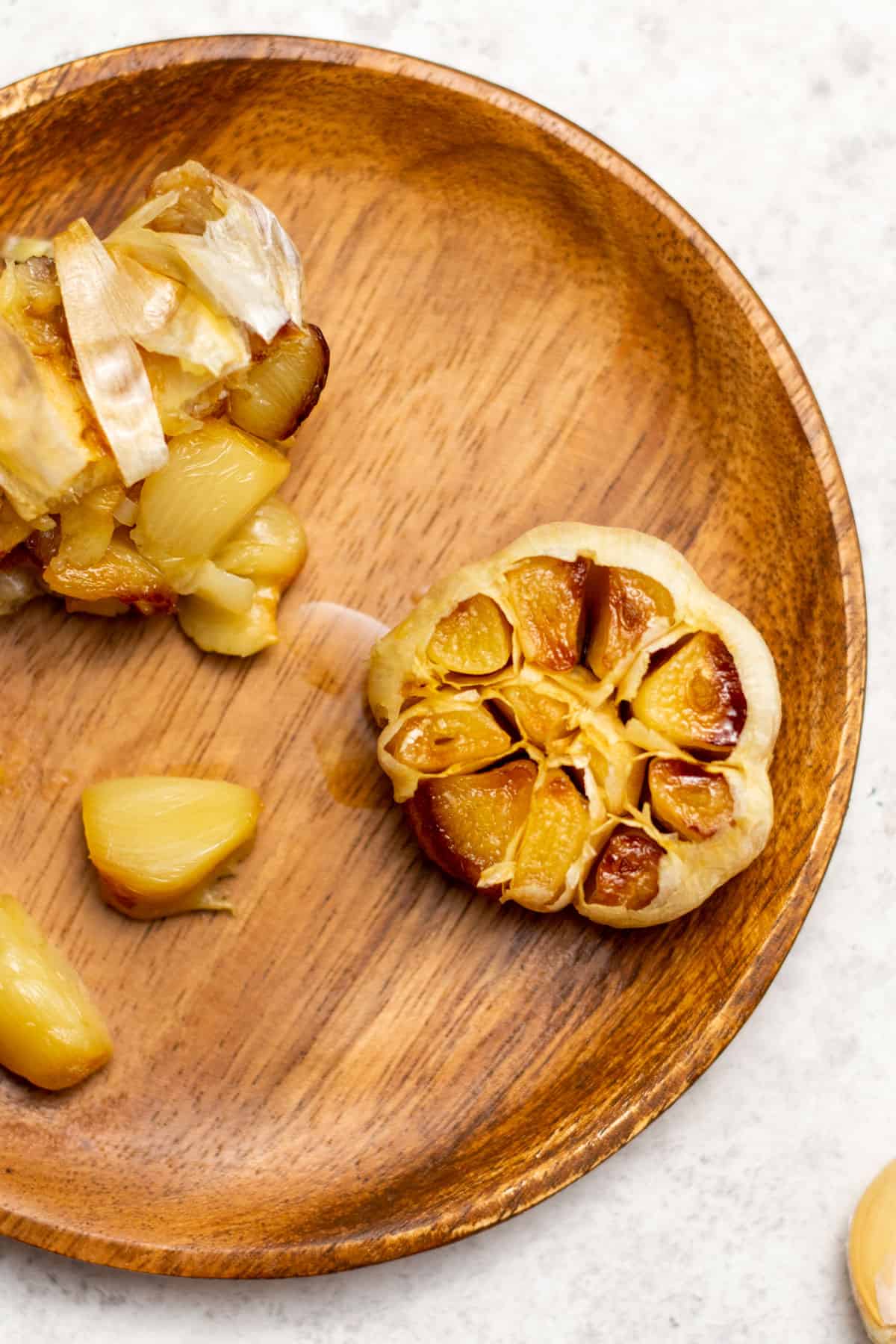 air fryer roasted garlic on a brown plate