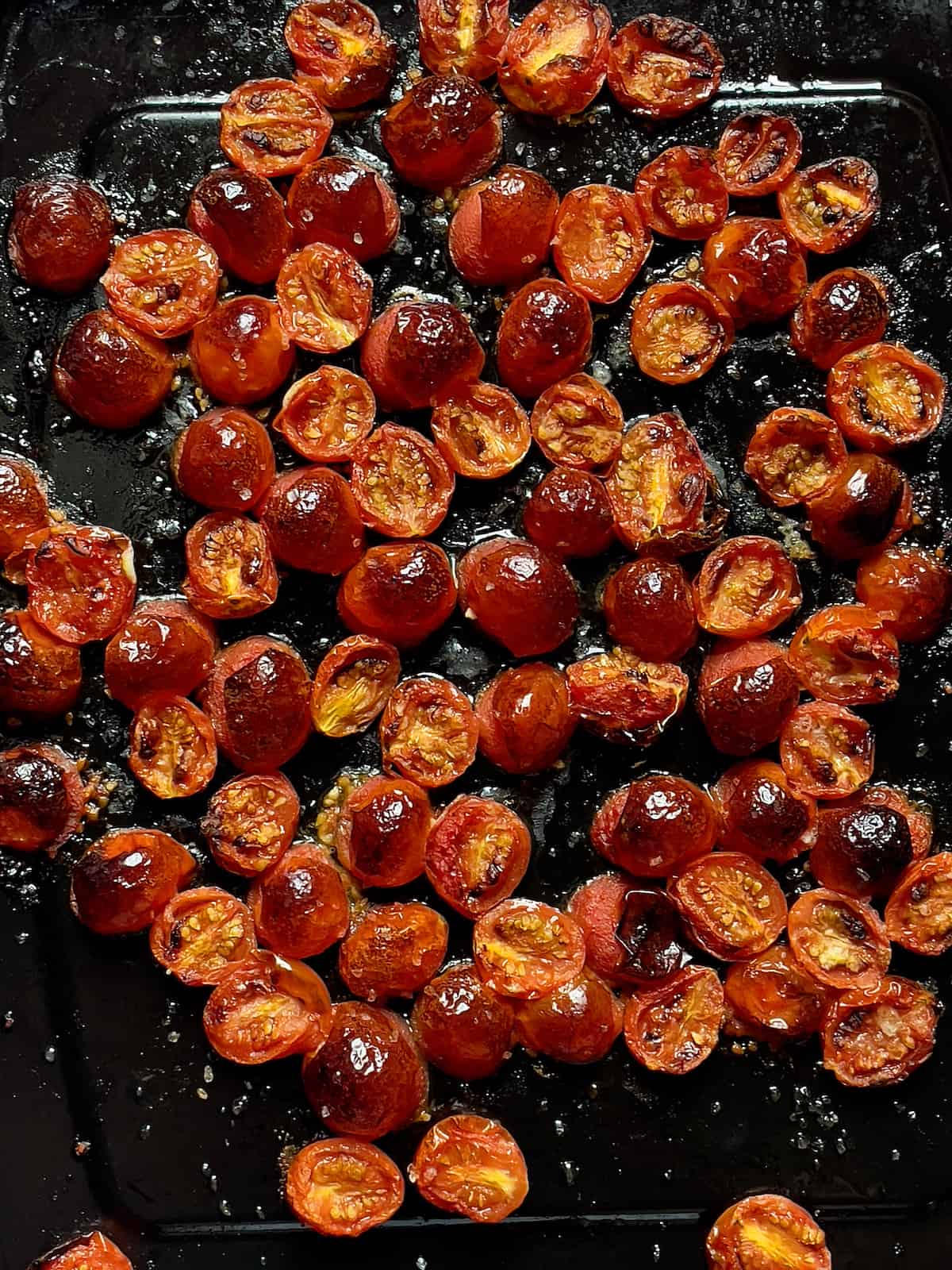 air fried cherry tomatoes on a black cooking pan