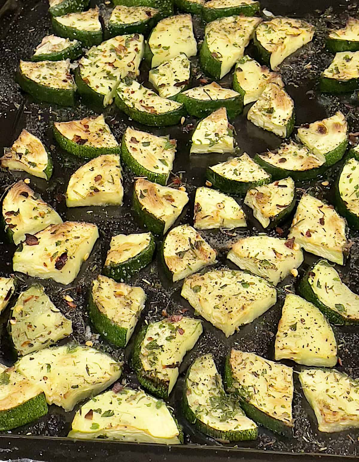 roasted zucchini with herbs on a tray