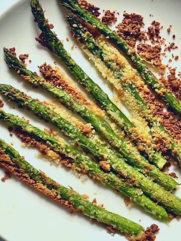 air fried parmesan asparagus on a white plate