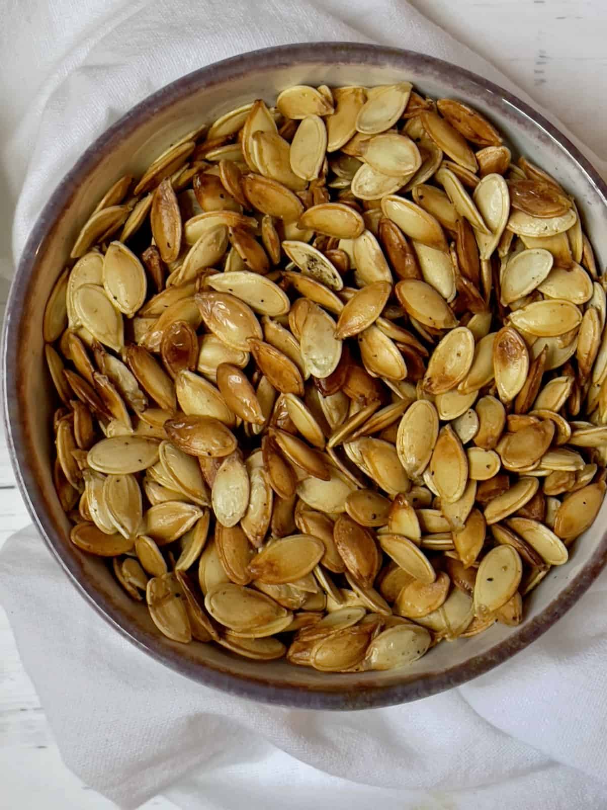 roasted pumpkin seeds close up in a small bowl