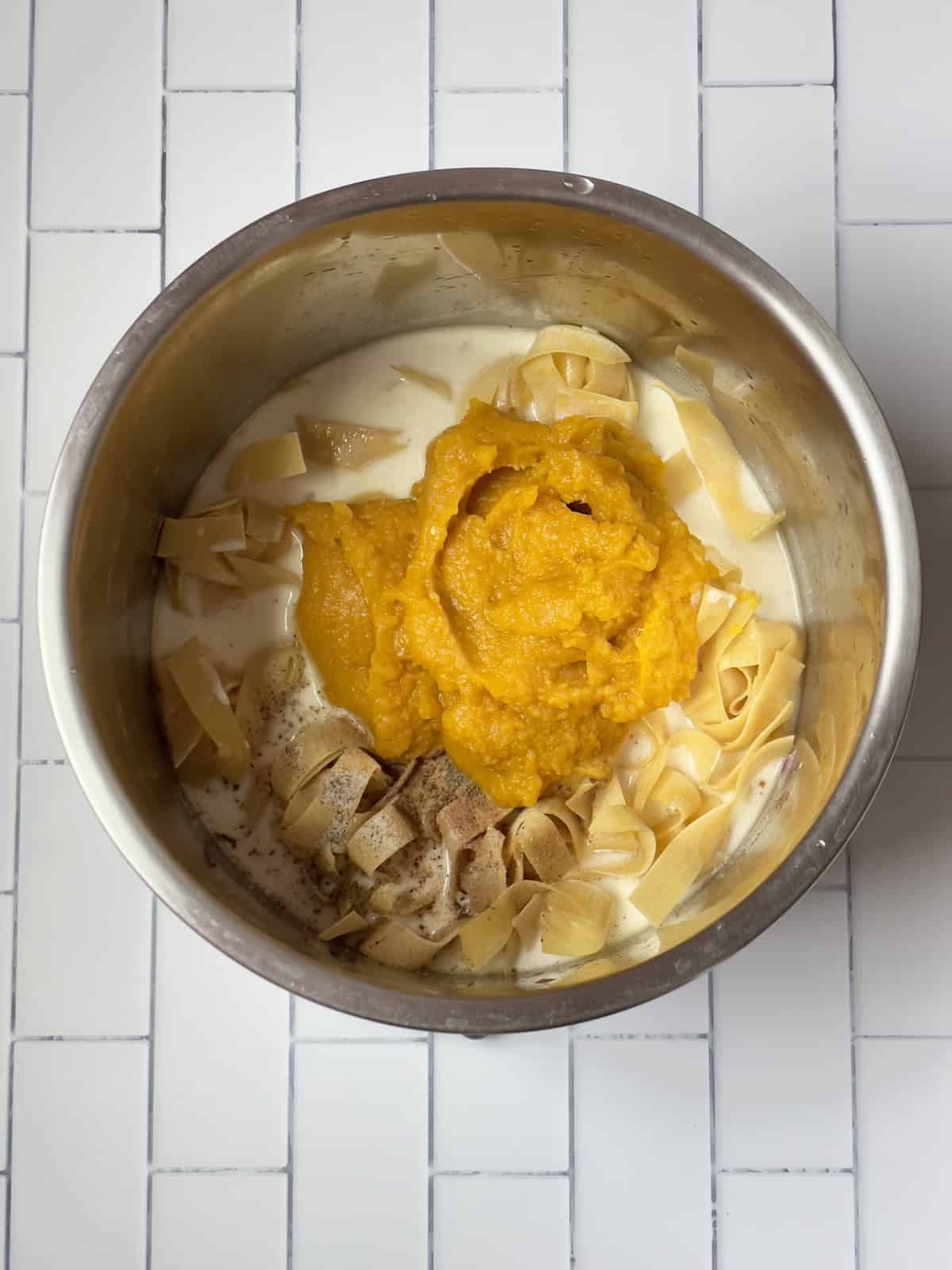 pasta, pumpkin puree, heavy cream, spices, and water in a pressure cooker