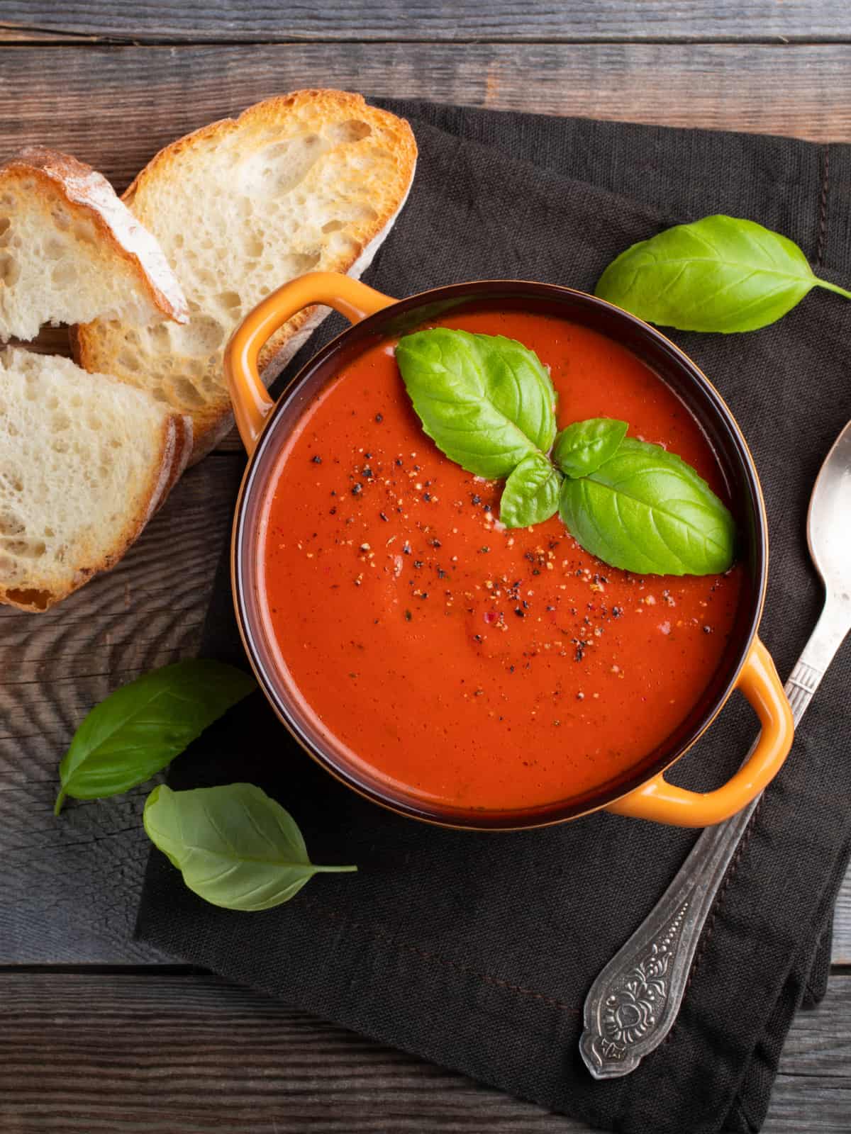 tomato soup topped with basil in a crok