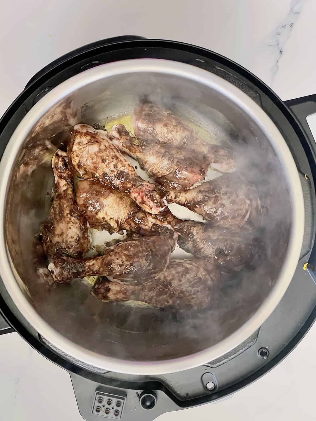 chicken drumsticks searing in an instant pot