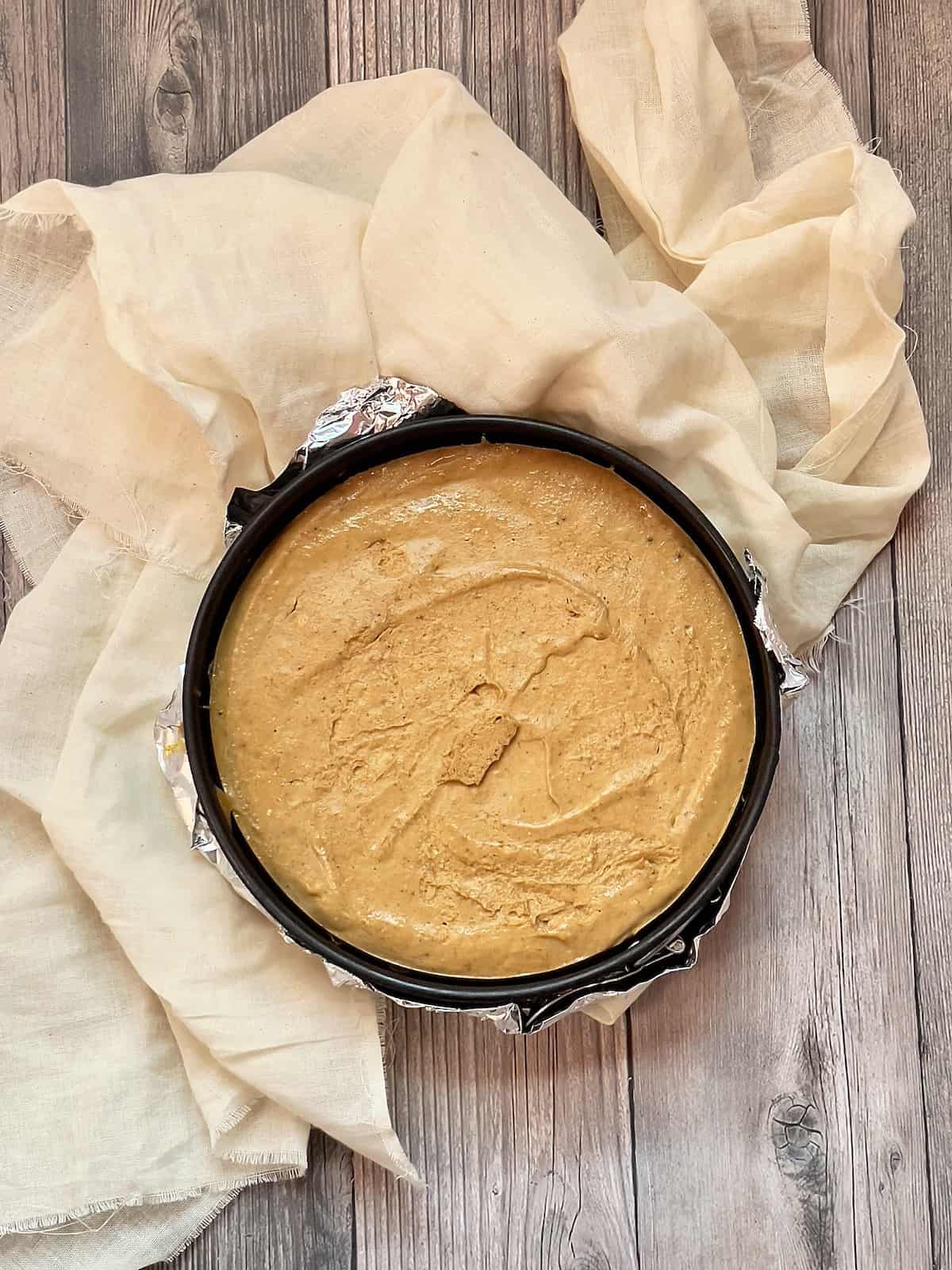 pumpkin cheesecake in a foil springform pan