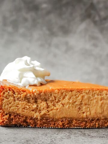 pumpkin spice cheesecake topped with whipped cream