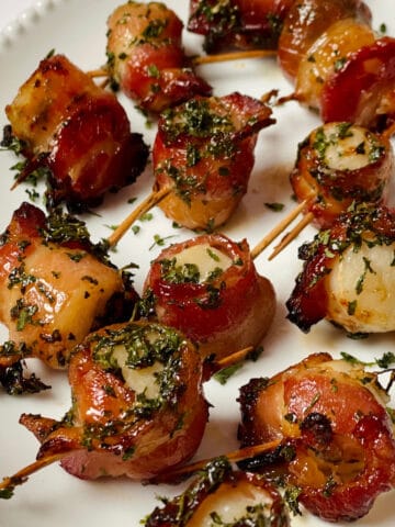 air fried bacon wrapped scallops on a white plate