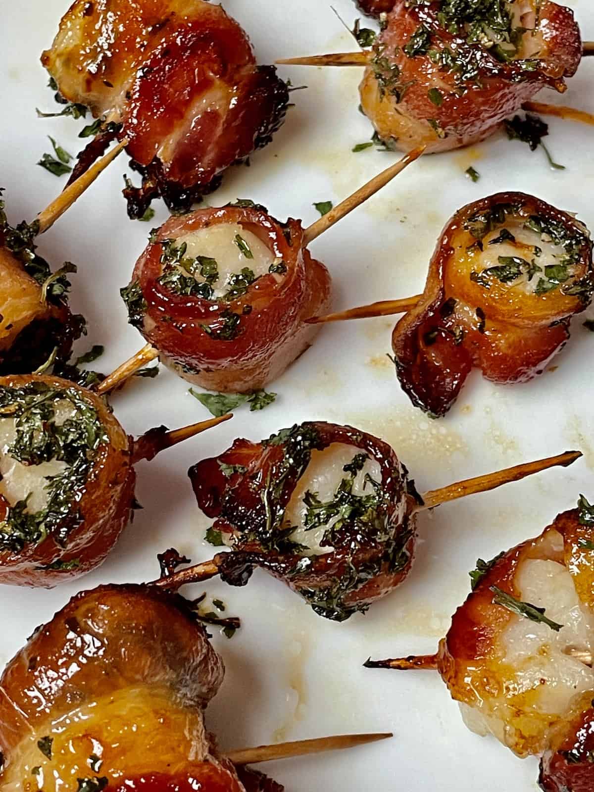 air fried bacon wrapped scallops on a white plate