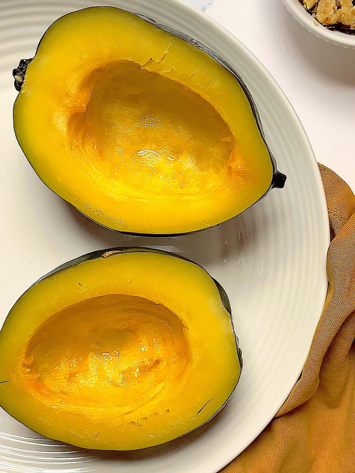 cooked acorn squash on a white plate