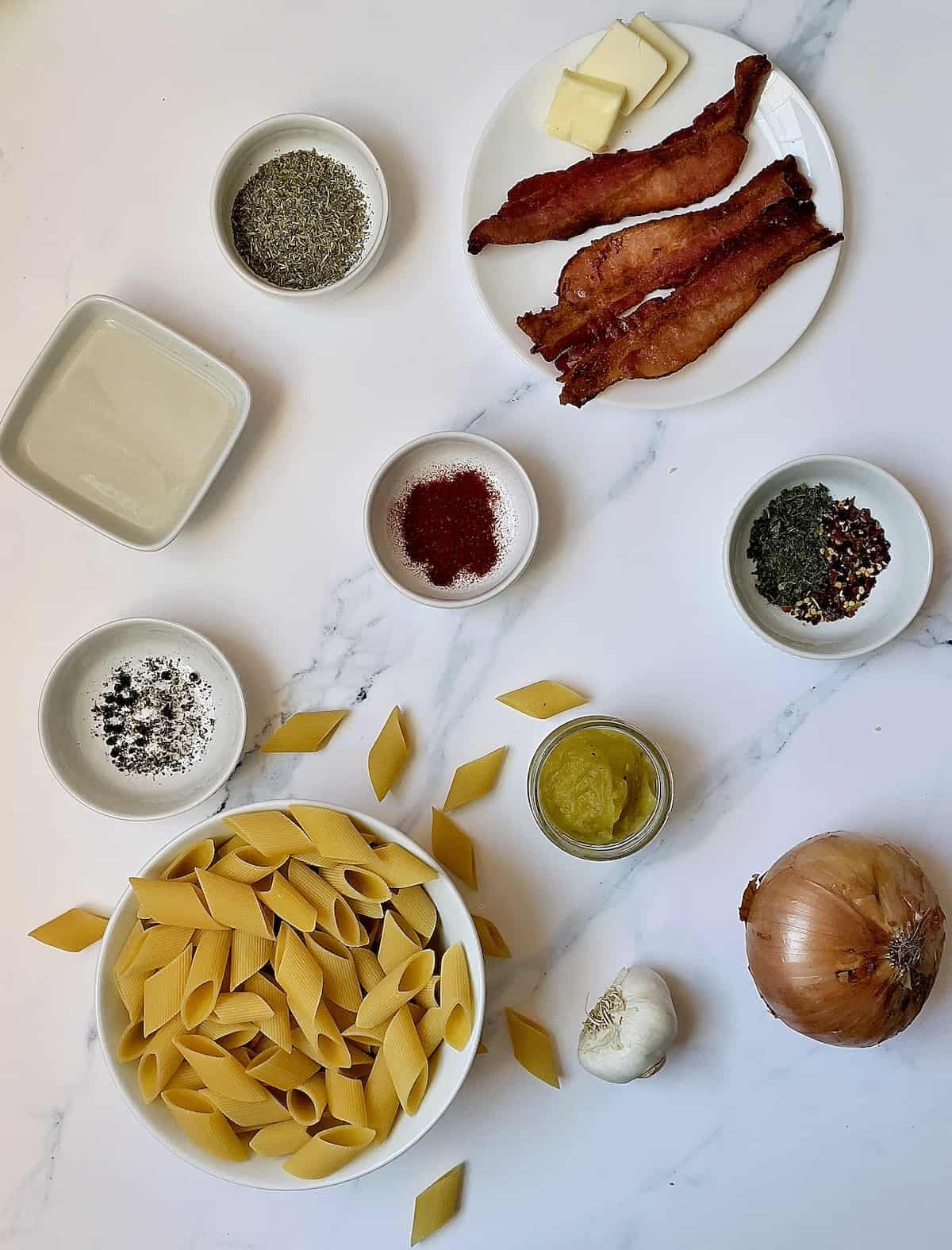 ingredients for acorn squash pasta on a white background