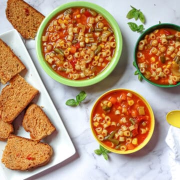 instant pot vegetable soup in 3 bowls with tomato bread