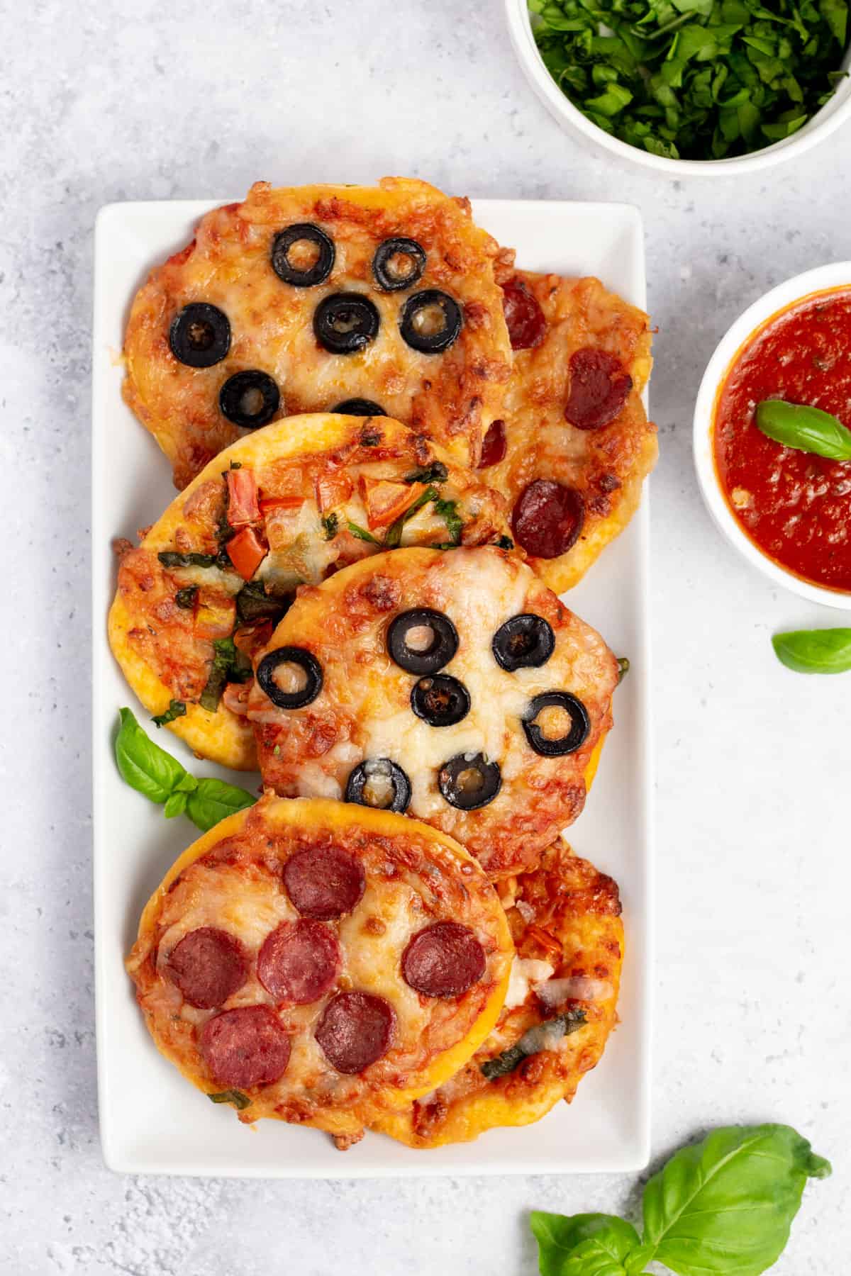 mini pizza with different toppings on a white plate