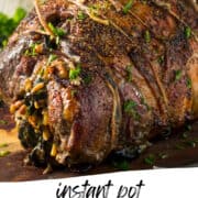 leg of lamb with herbs wrapped in kitchen twine on a cutting board