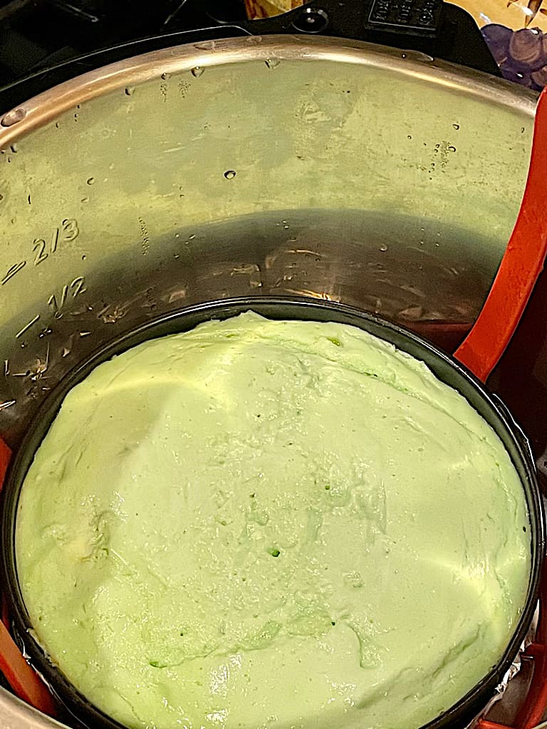 cooked mint cheesecake uncovered in the inner pot of the pressure cooker