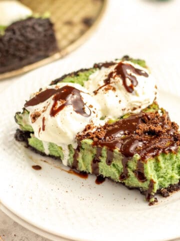 a slice of mint chocolate cheesecake on a white plate