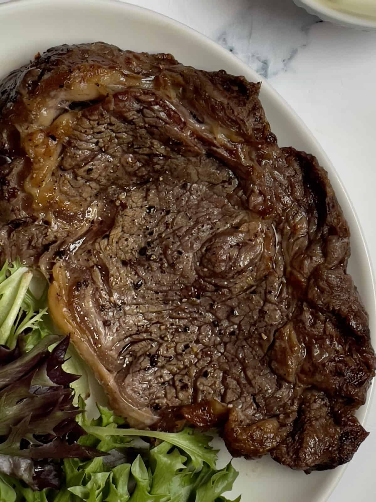air fryer ribeye steak on a white plate