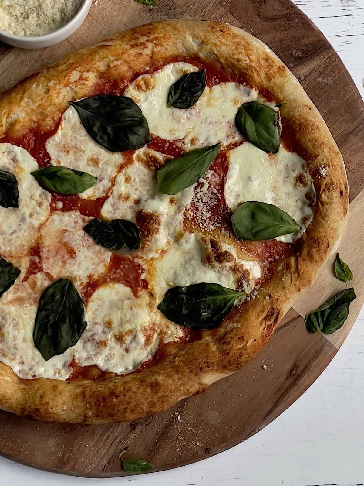 authentic neapolitan style pizza on a wooden pizza peel