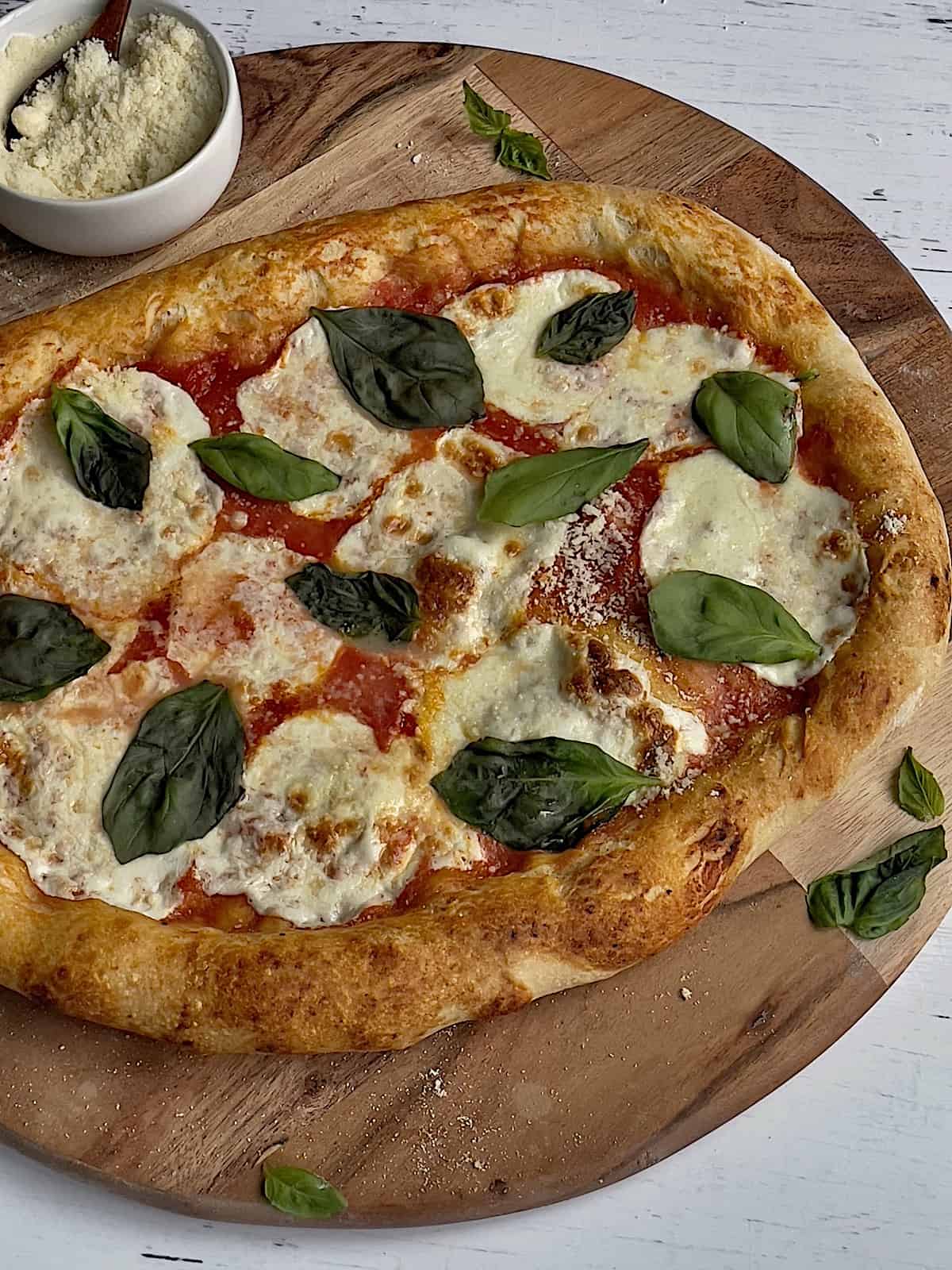 authentic neapolitan style pizza on a wooden pizza peel