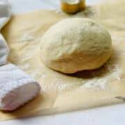 pizza dough ball on parchment paper