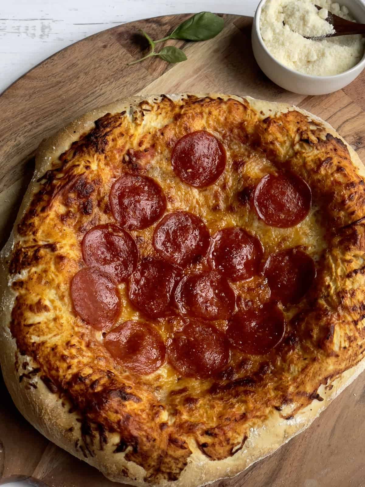 pepperoni pizza on a wooden pizza peel