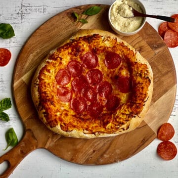pepperoni pizza on a wooden pizza peel