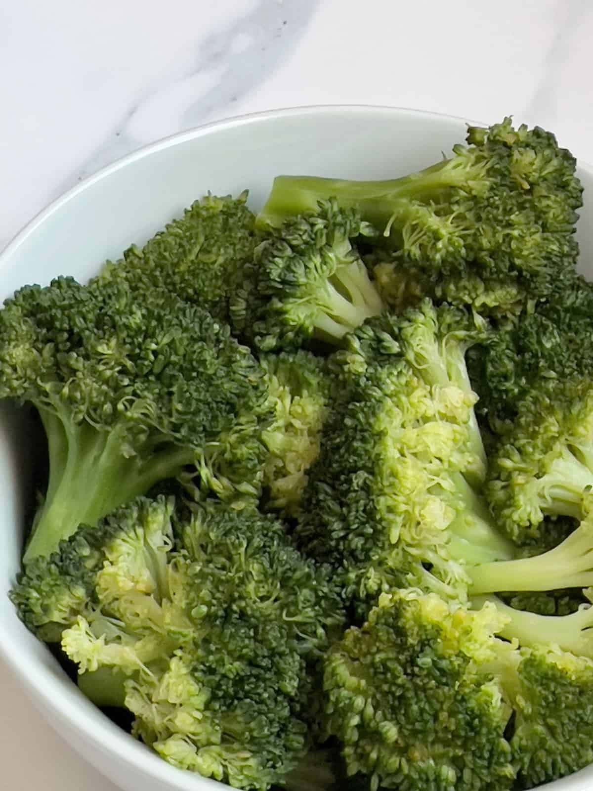 instant pot broccoli in a white serving bowl
