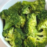 pressure cooked broccoli florets in a white bowl