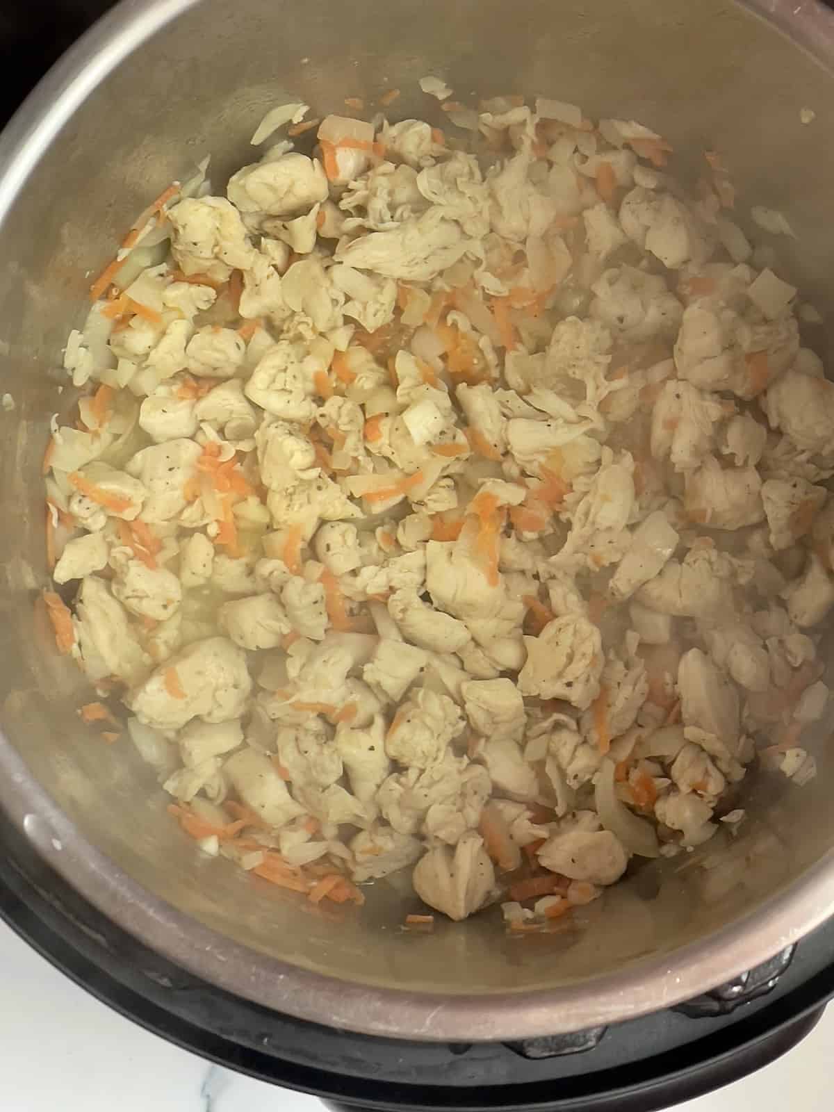 grated carrots, chicken, onion, in the inner pot of an Instant Pot