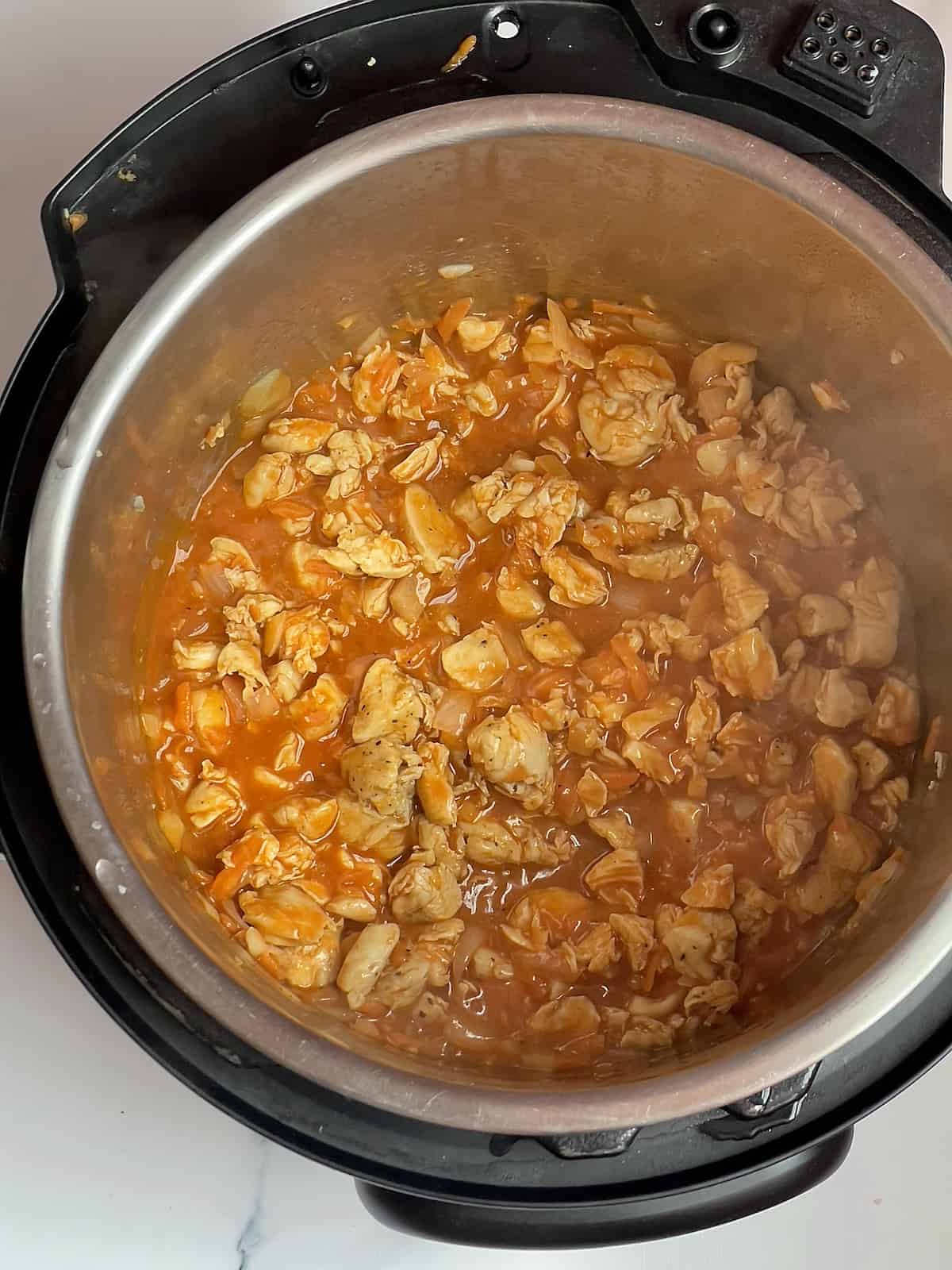 diced chicken with buffalo sauce in an Instant Pot