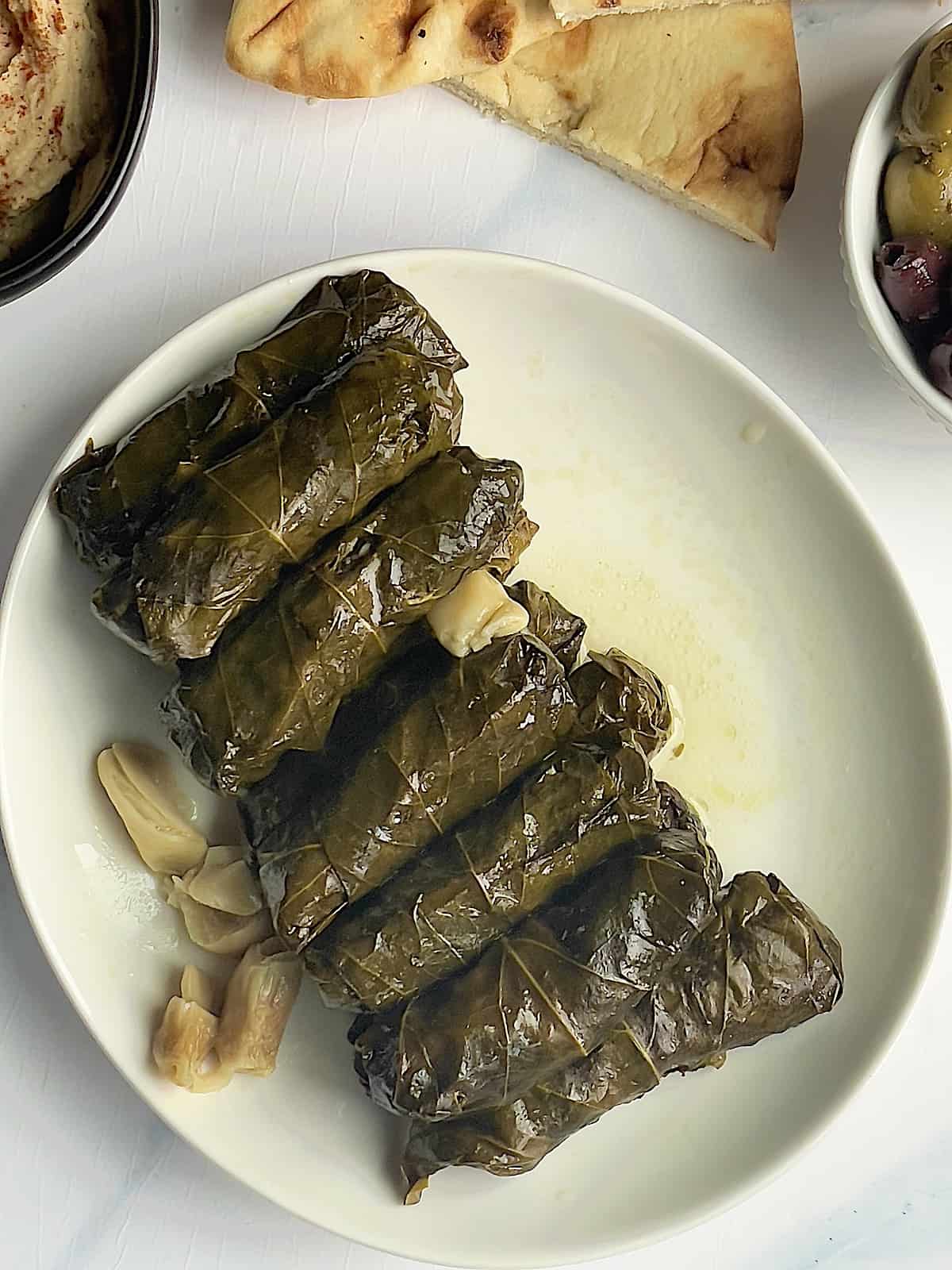 Instant pot stuffed grape leaves on a white plate