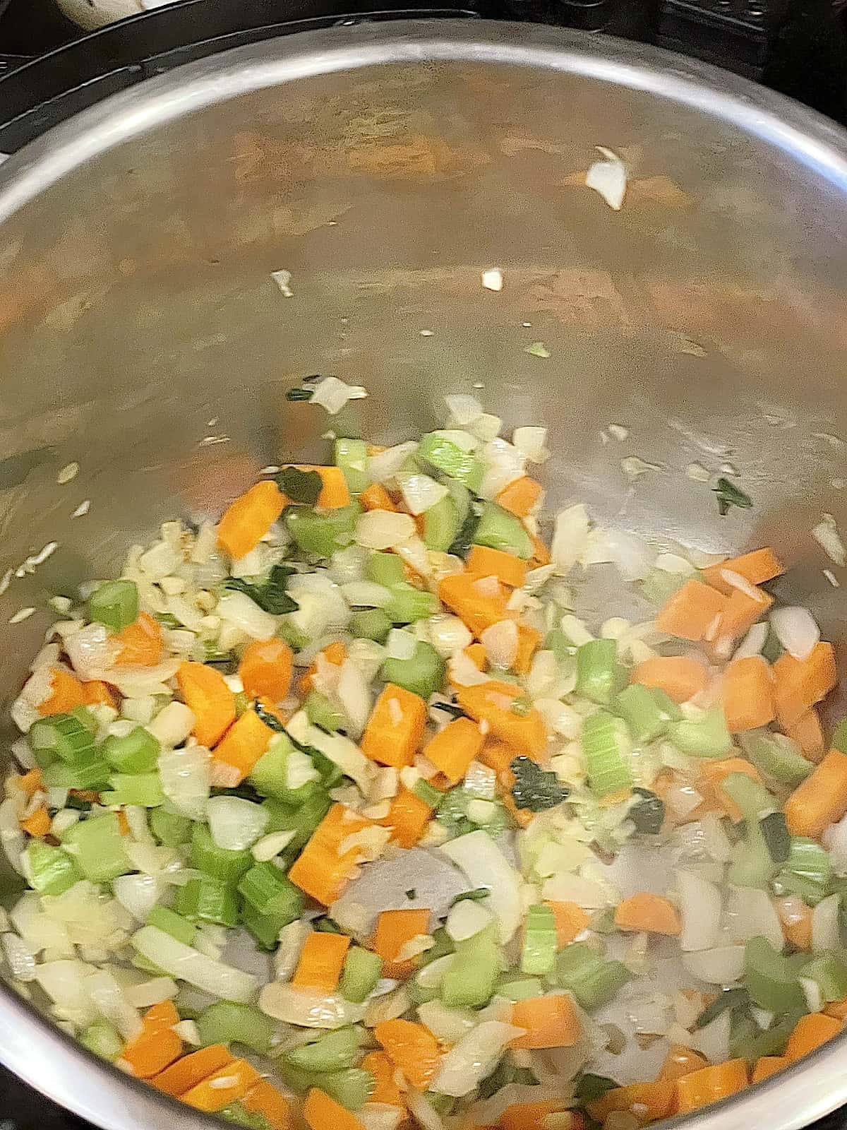 carrots, celery, garlic and onions cooking in the pressure cooker