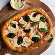 authentic neapolitan style pizza on a wooden pizza peel