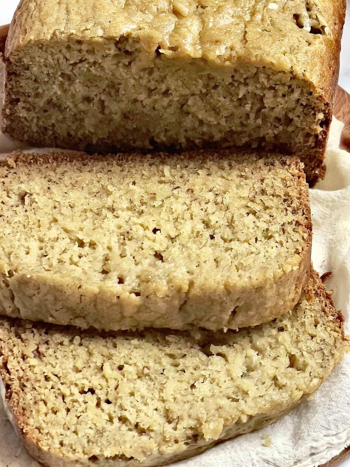 bread machine banana bread sliced on a cutting board