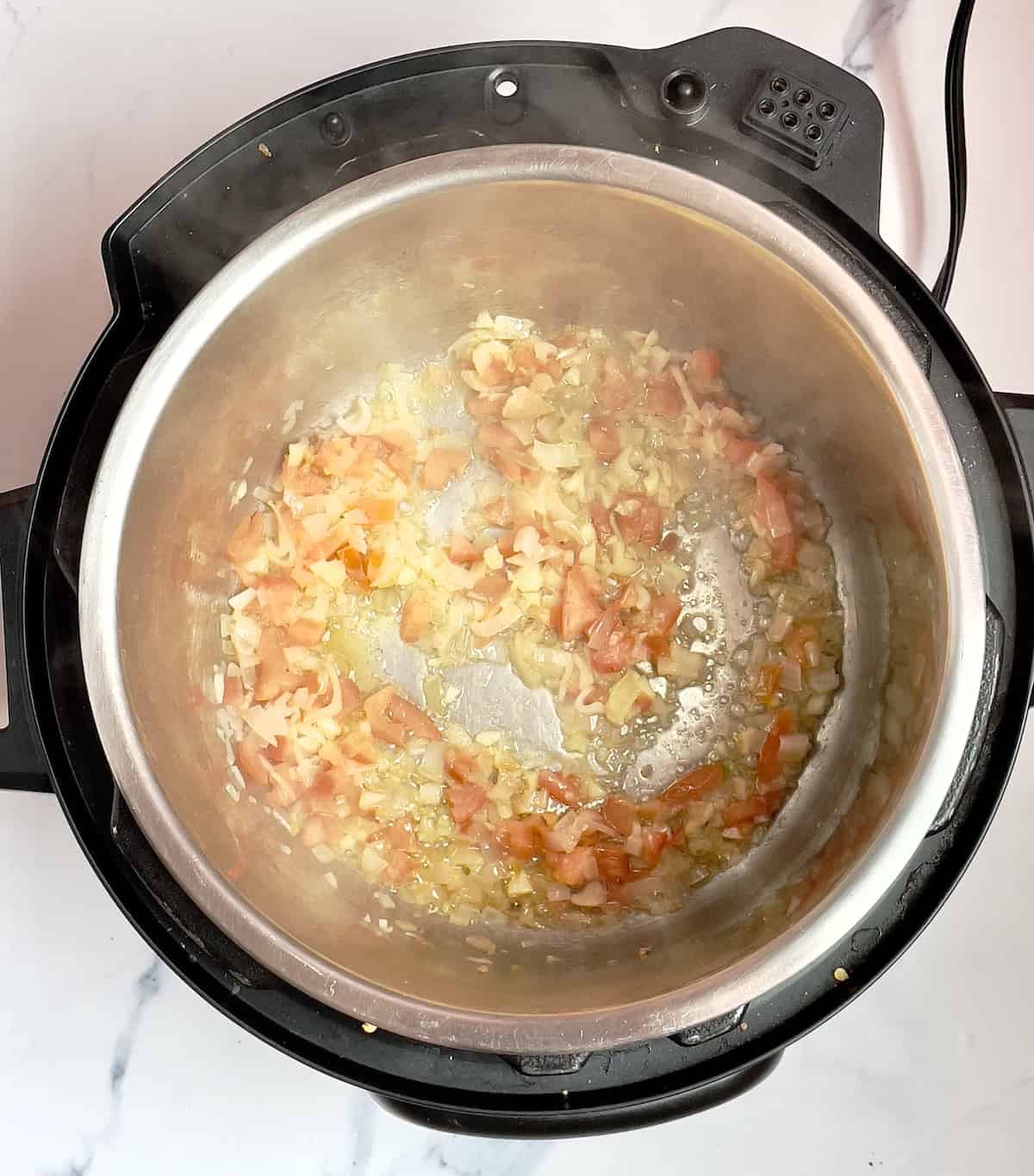 tomatoes, shallot and onion cooking in the instant pot