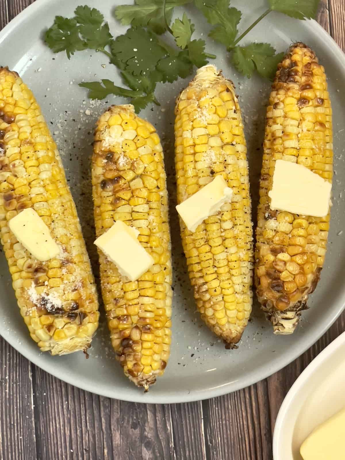 air fried corn on the cob on a gray plate