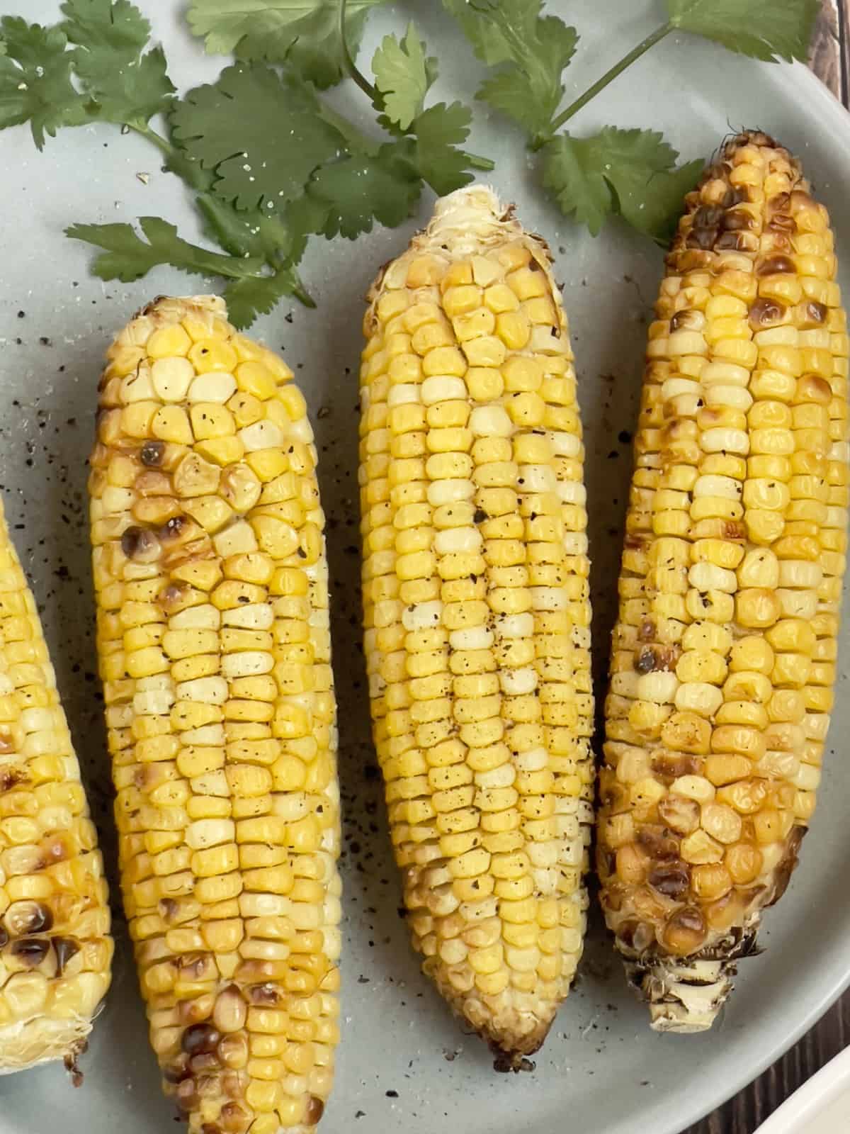 air fryer corn on the cob on a gray plate