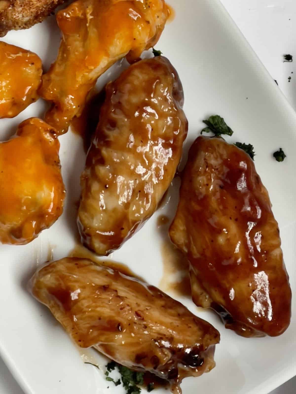 close up of barbecue style chicken wings and buffalo wings