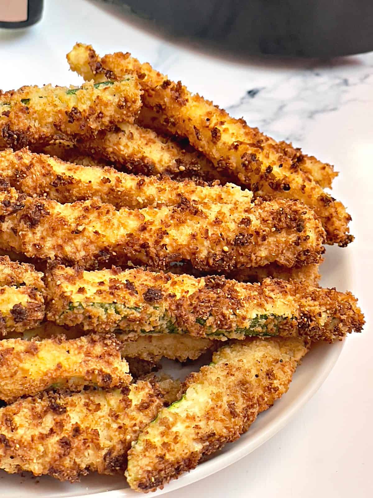 air fryer zucchini fries on a white plate