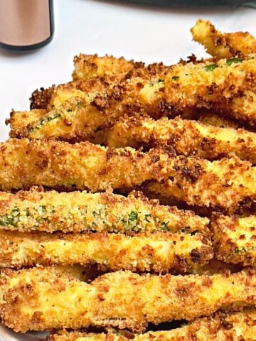 air fryer zucchini fries on a white plate