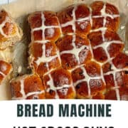 bread machine hot cross buns on a parchment paper decorated with icing crosses