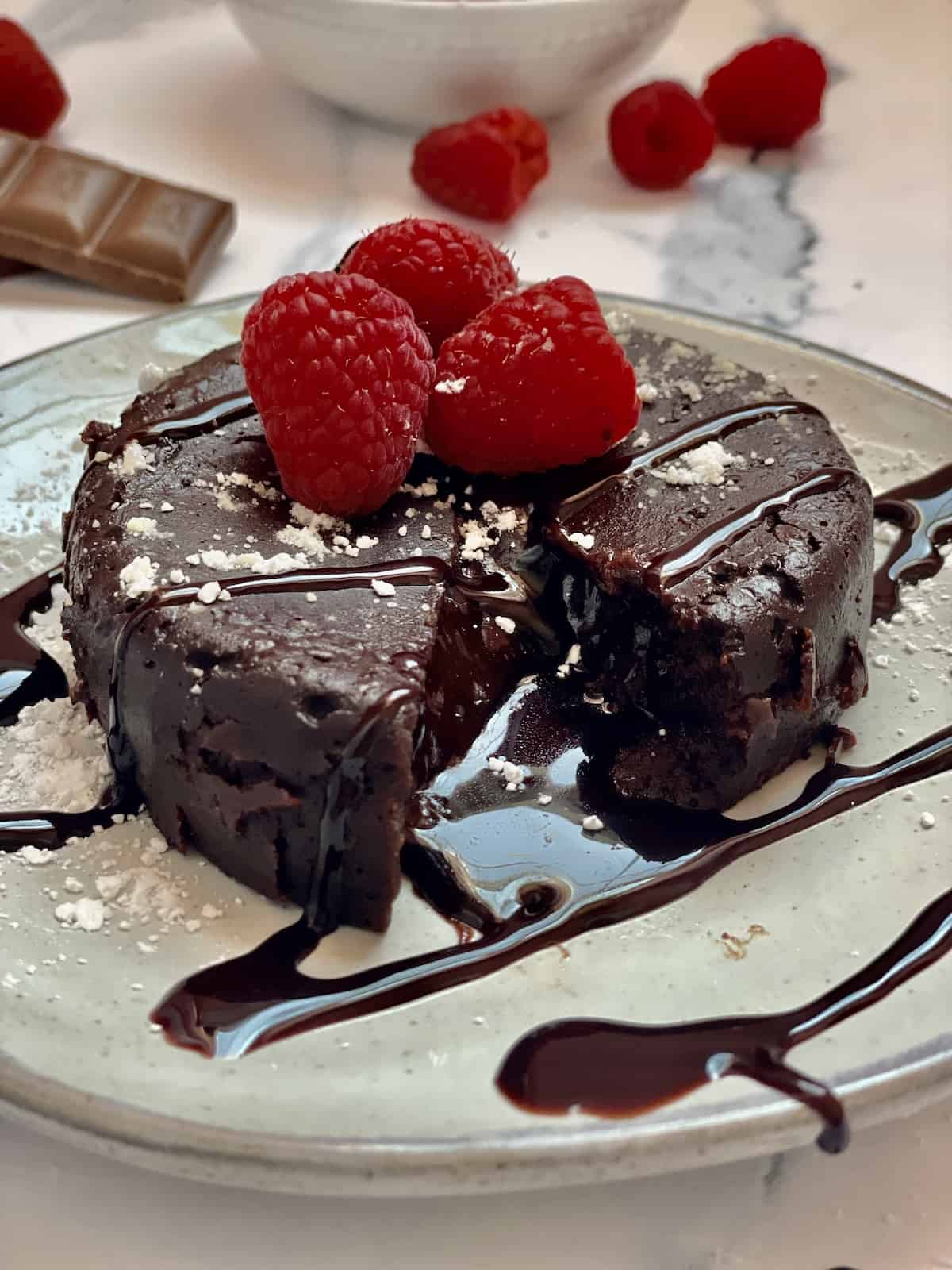 instant pot molten lava cake topped with powdered sugar and raspberries