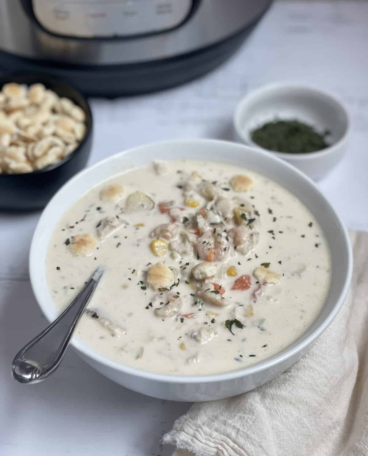 pressure cooked creamy seafood chowder in a white bowl