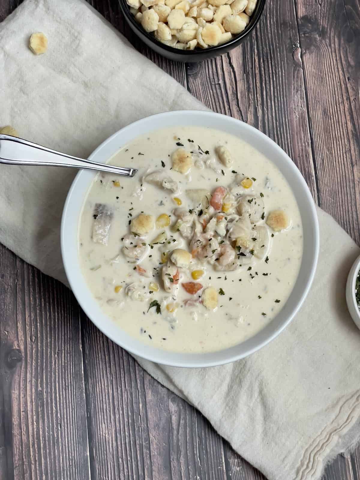 creamy instant pot seafood chowder in a white bowl