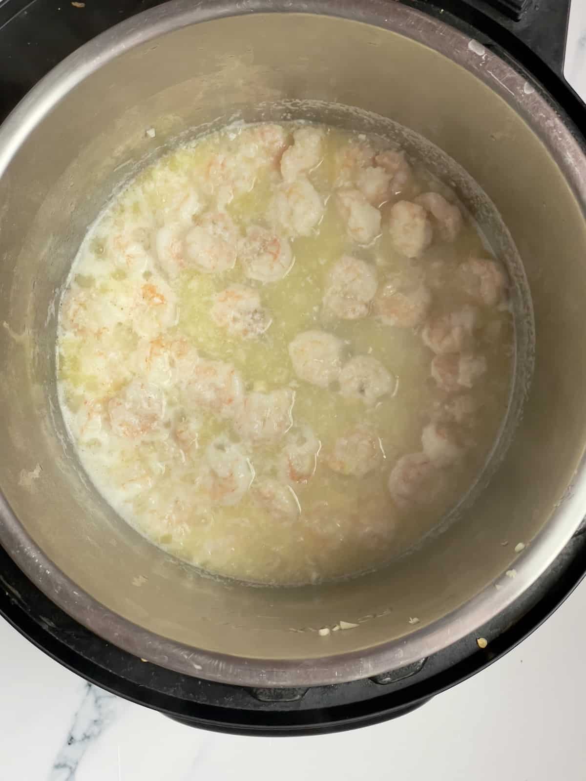 shrimp, shallots and garlic cooking in an inner pot