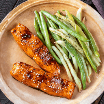 air fried frozen salmon on a plate with beans